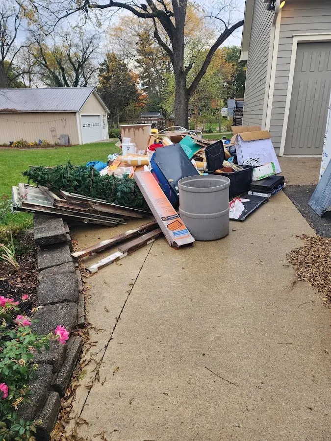 Dumpster being loaded with debris for Commercial Dumpster Rental in St. Rose